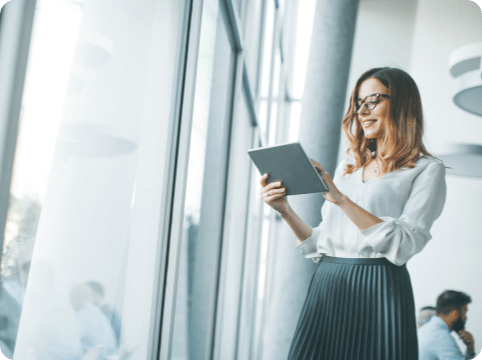 Woman holding tablet in front of window