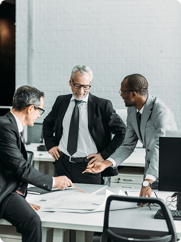 Businessmen smiling, looking at business plans