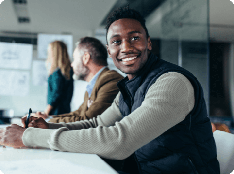 Woman presenting slideshow, man smiling and looking to the left