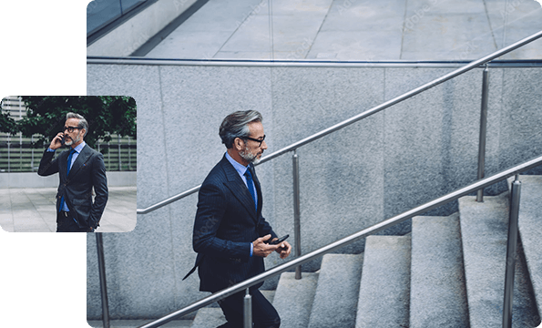 Businessman walking up stairs, businessman talking on phone